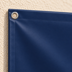 Close-up of navy PVC banner with welded reinforced edge and metal eyelet